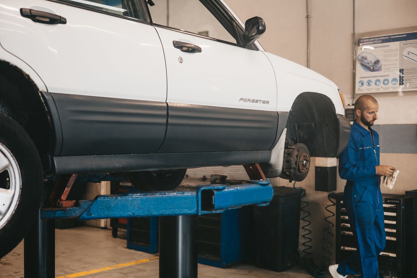 Vehicle raised on a workshop lift undergoing repair