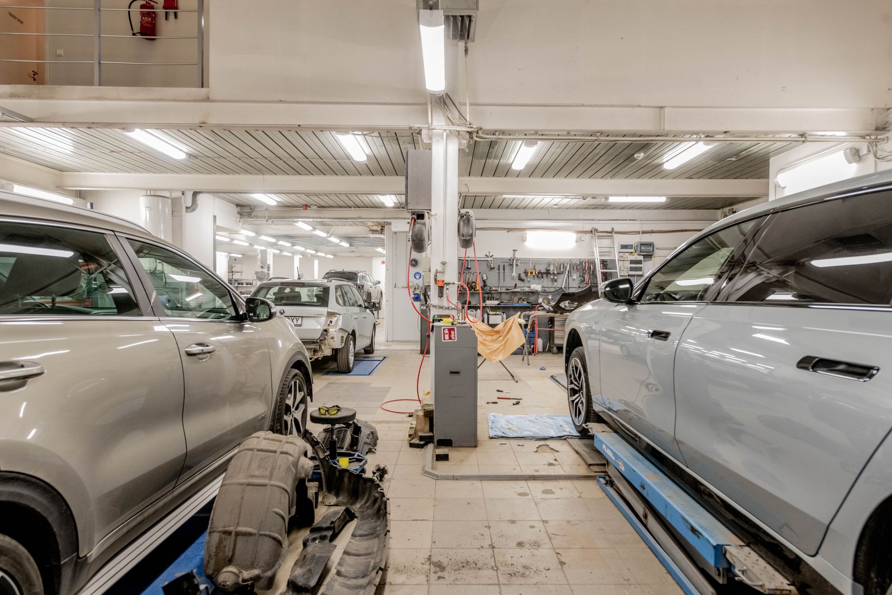 Service bays with vehicles raised on lifts